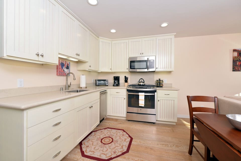 The kitchen has high-end appliances and everything you need to cook a nice meal.
