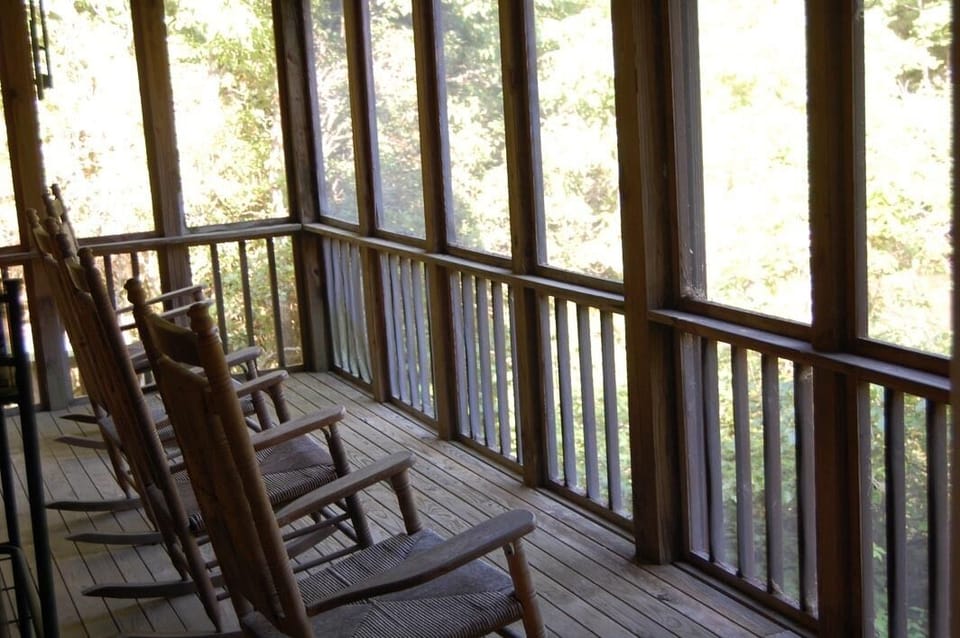 Rock away the stress on screened-in porch over river.