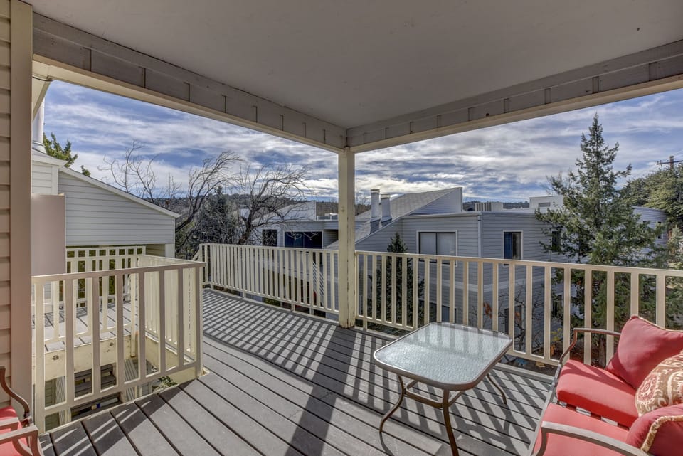 Second floor covered patio with seating for four
