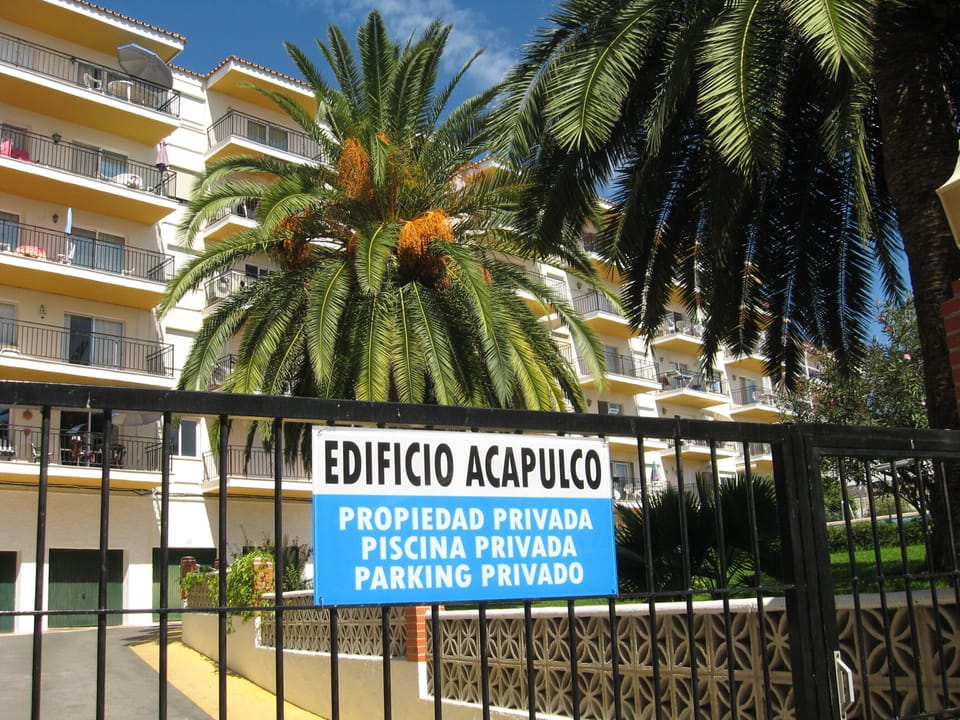 Private, locked  entrance to Edificio Alcapulco with parking behind building