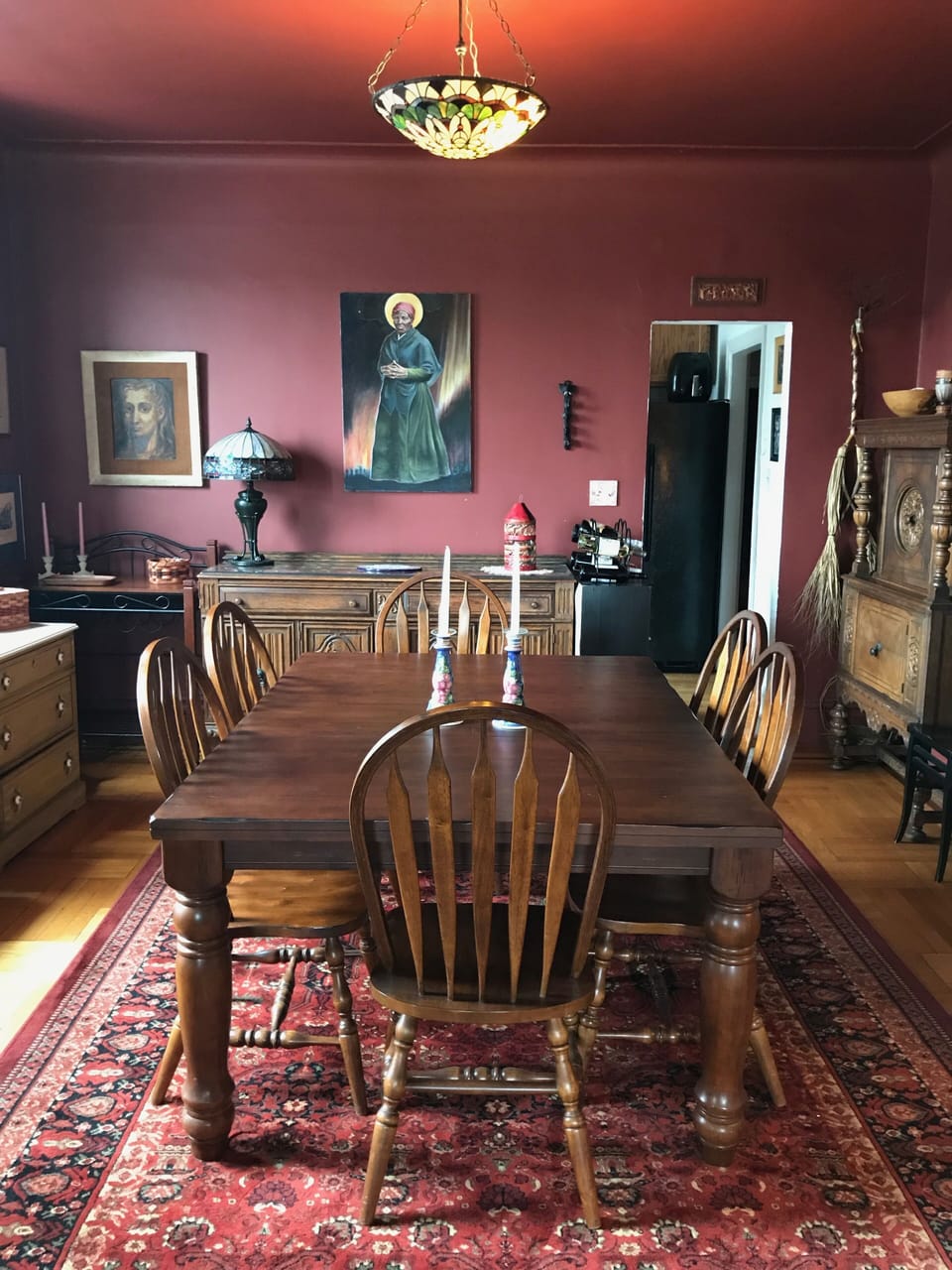 Dining room with antique buffet and sideboard and original artwork