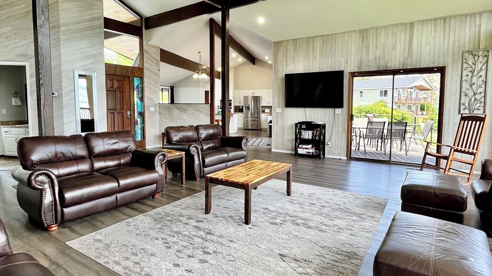 Large living room with plush leather couches and open spaces