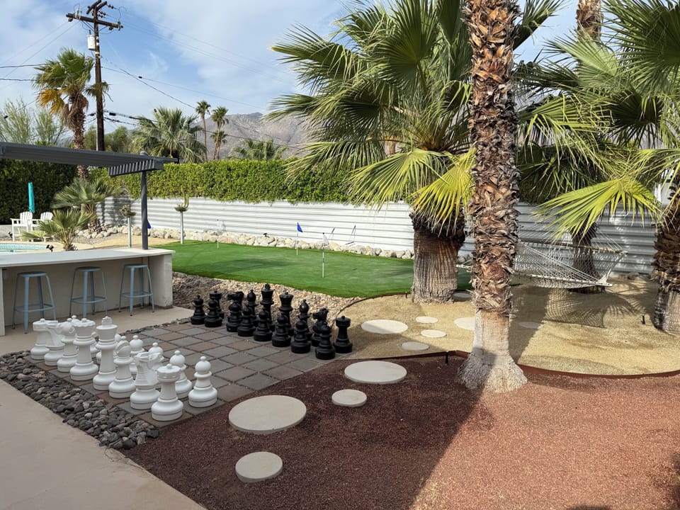 View of putting green, chess set, hammock and outdoor seating