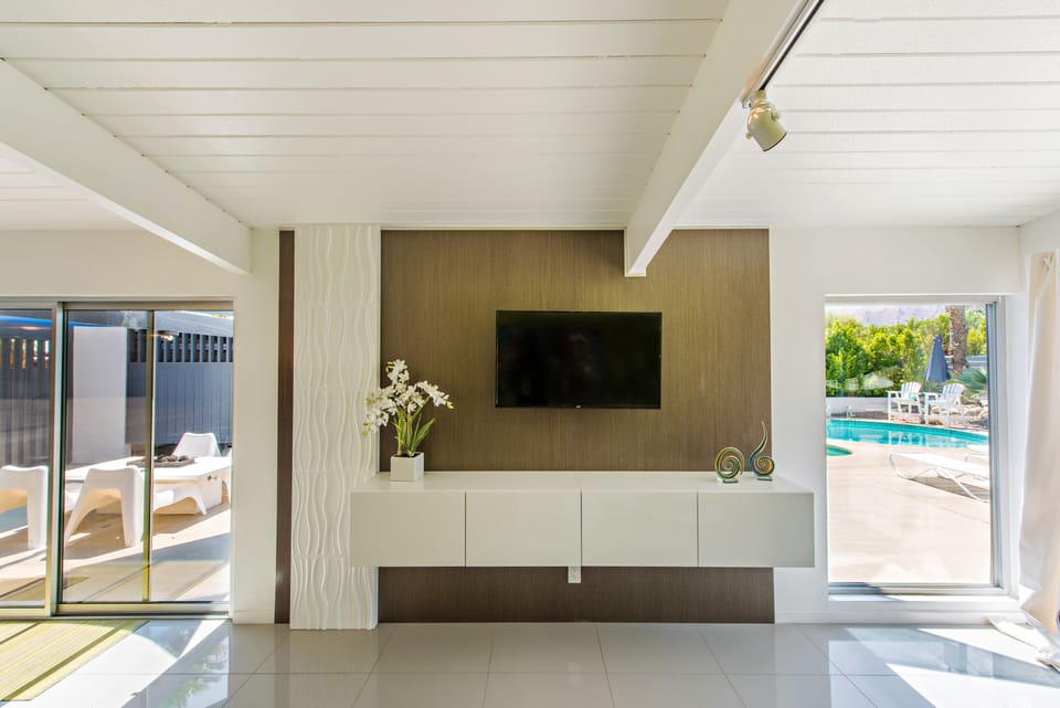 Bright, sunny living room looking into back yard