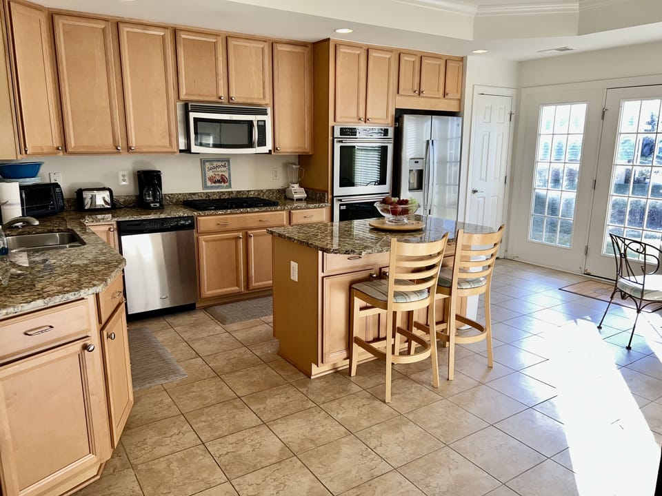Fully equipped kitchen w/ stainless steel appliances, gas cooking & granite tops