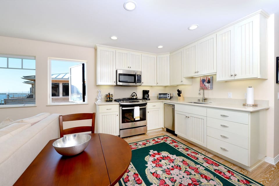 The kitchen has high-end appliances and everything you need to cook a nice meal.