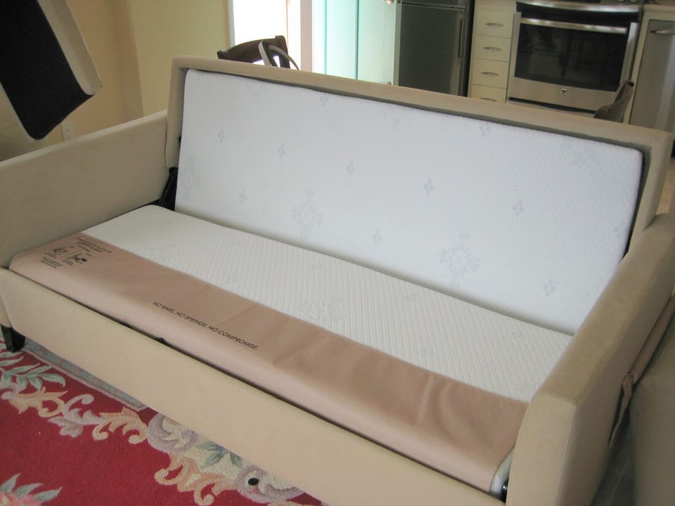 The living room has a foldout queen-size bed. You will not believe how comfortable this memory foam foldout bed is