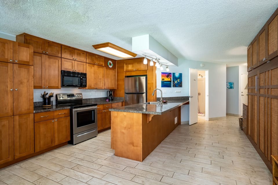 Large kitchen area with bar. Adjacent to queen murphy bed.