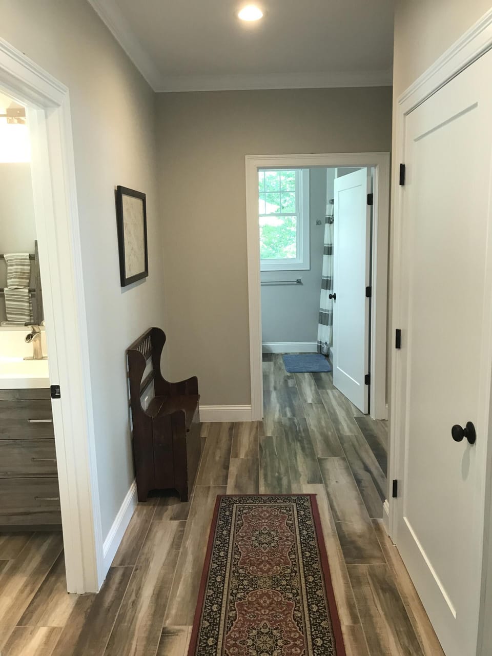 First floor hallway with half bath and full bath in view