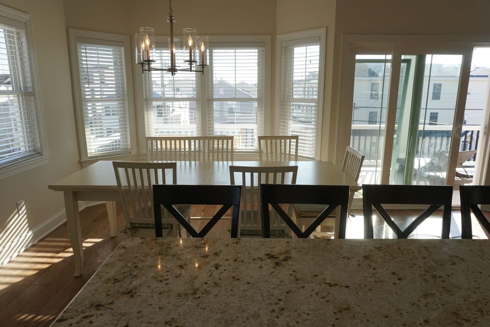 Kitchen table seats 8-9. There are also 4 bar stools on the island. 