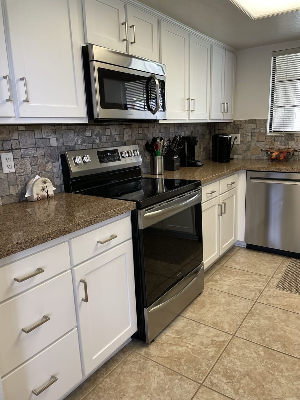 Updated kitchen with stainless steel appliances and quartz countertops.