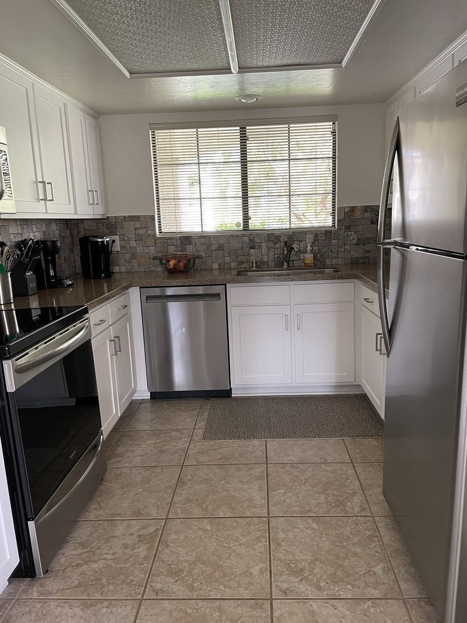 Updated kitchen with stainless steel appliances and quartz countertops.