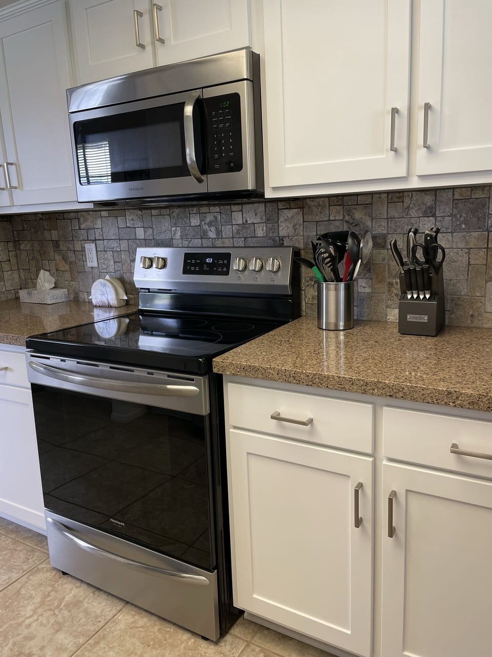 Updated kitchen with stainless steel appliances and quartz countertops.