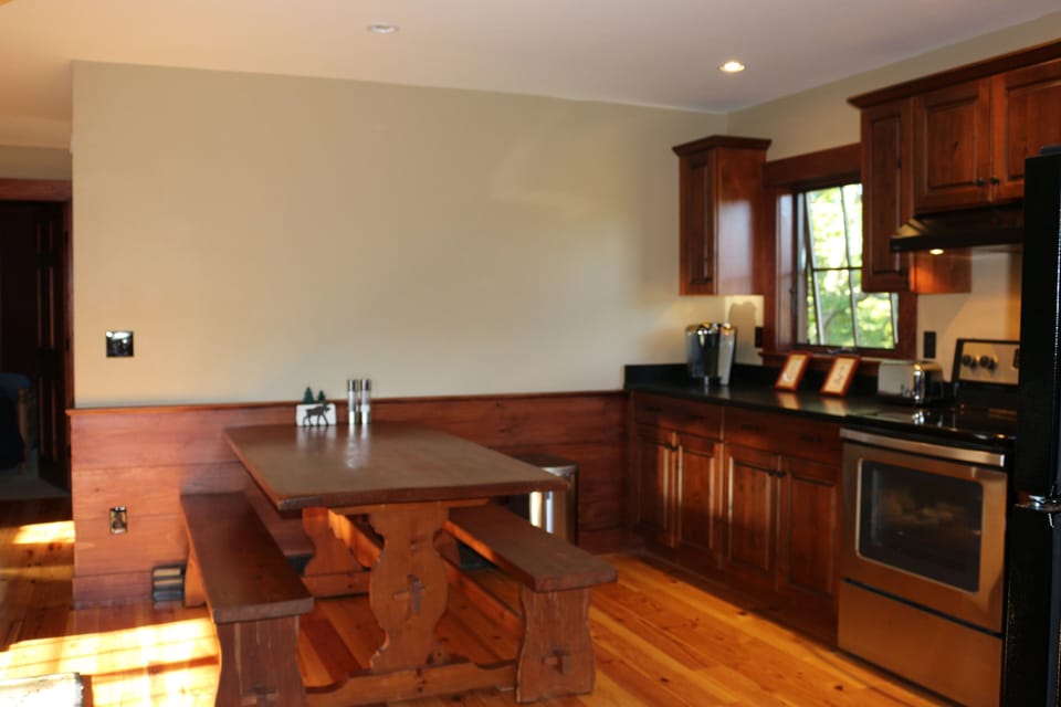 Large, warm trestle table in the kitchen comfortably seats 6-8.