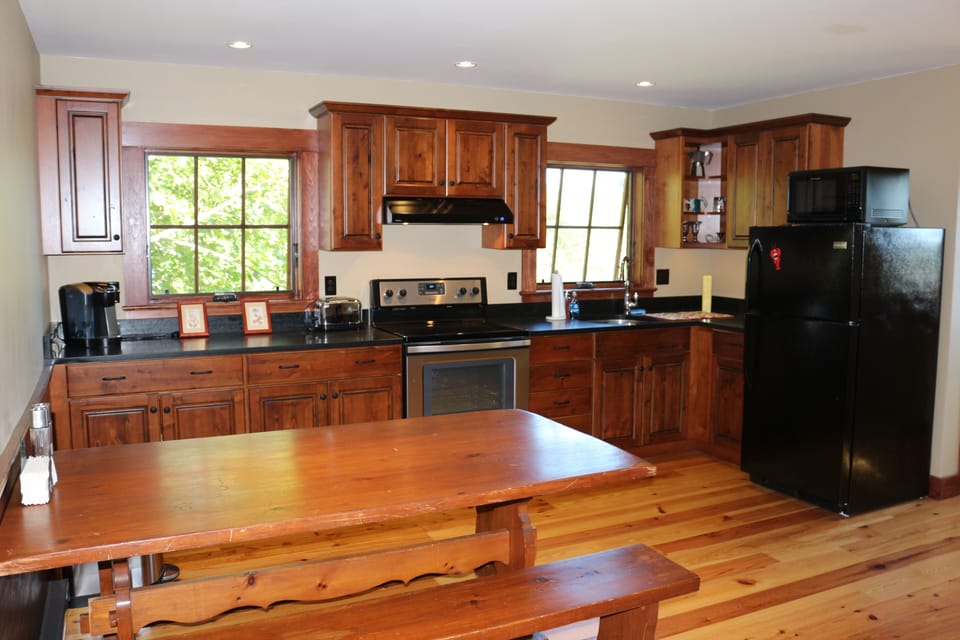 Honed black granite counters and rustic alder cabinets... nice, beautiful space.