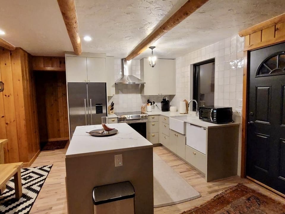 Open concept living, dining and kitchen - complete with a wood burning stove!