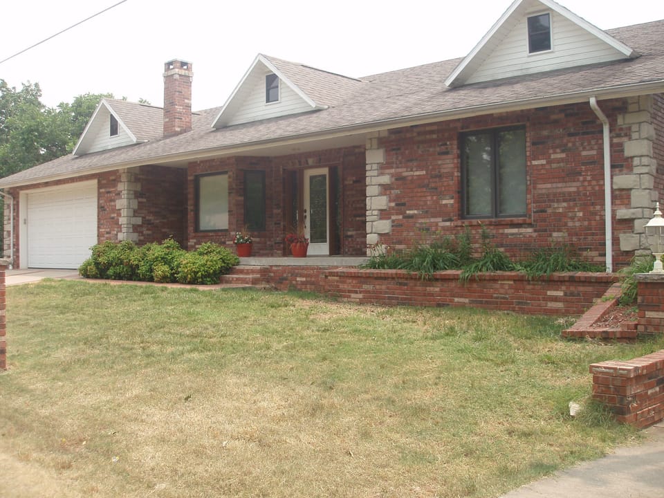 Front of house with double car garage. House is much larger than it appears.