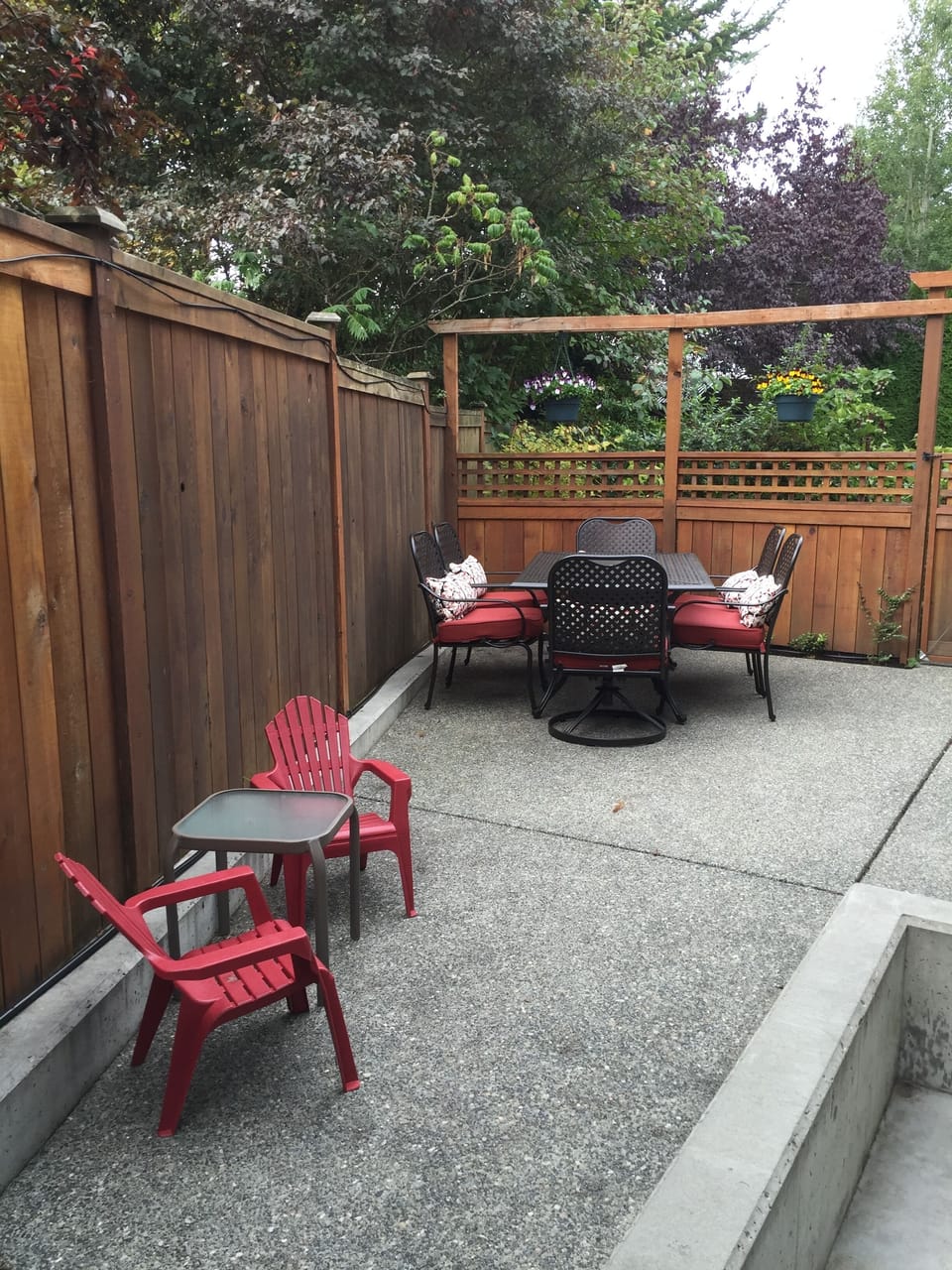 Fully fenced, private patio with seating and BBQ.