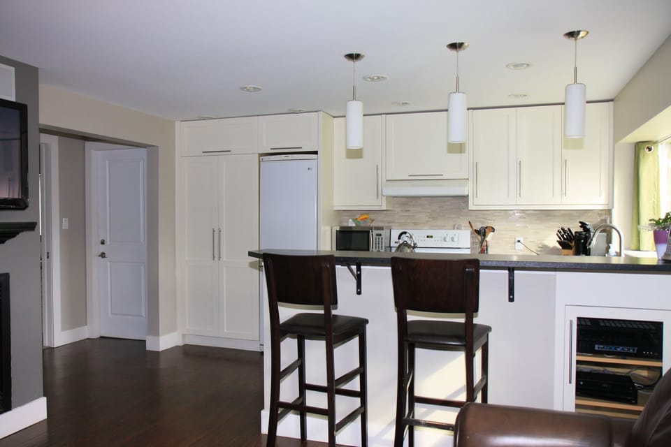 Wide archway leads into laundry, bathroom, and bedroom.