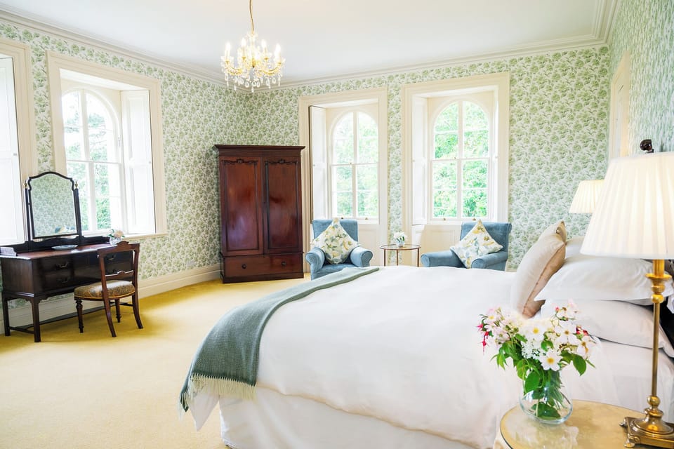 Stunning guest bedroom suite stunning views over parkland a mountain backdrop.