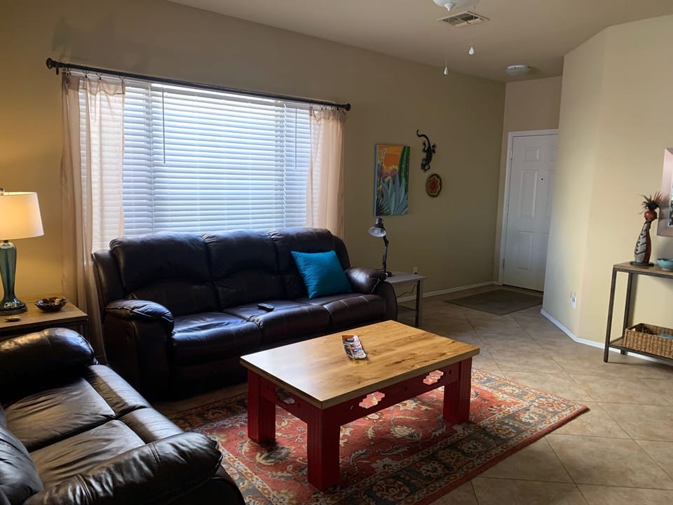 The front entry of the house leads to the Great Room,  with large screen tv.