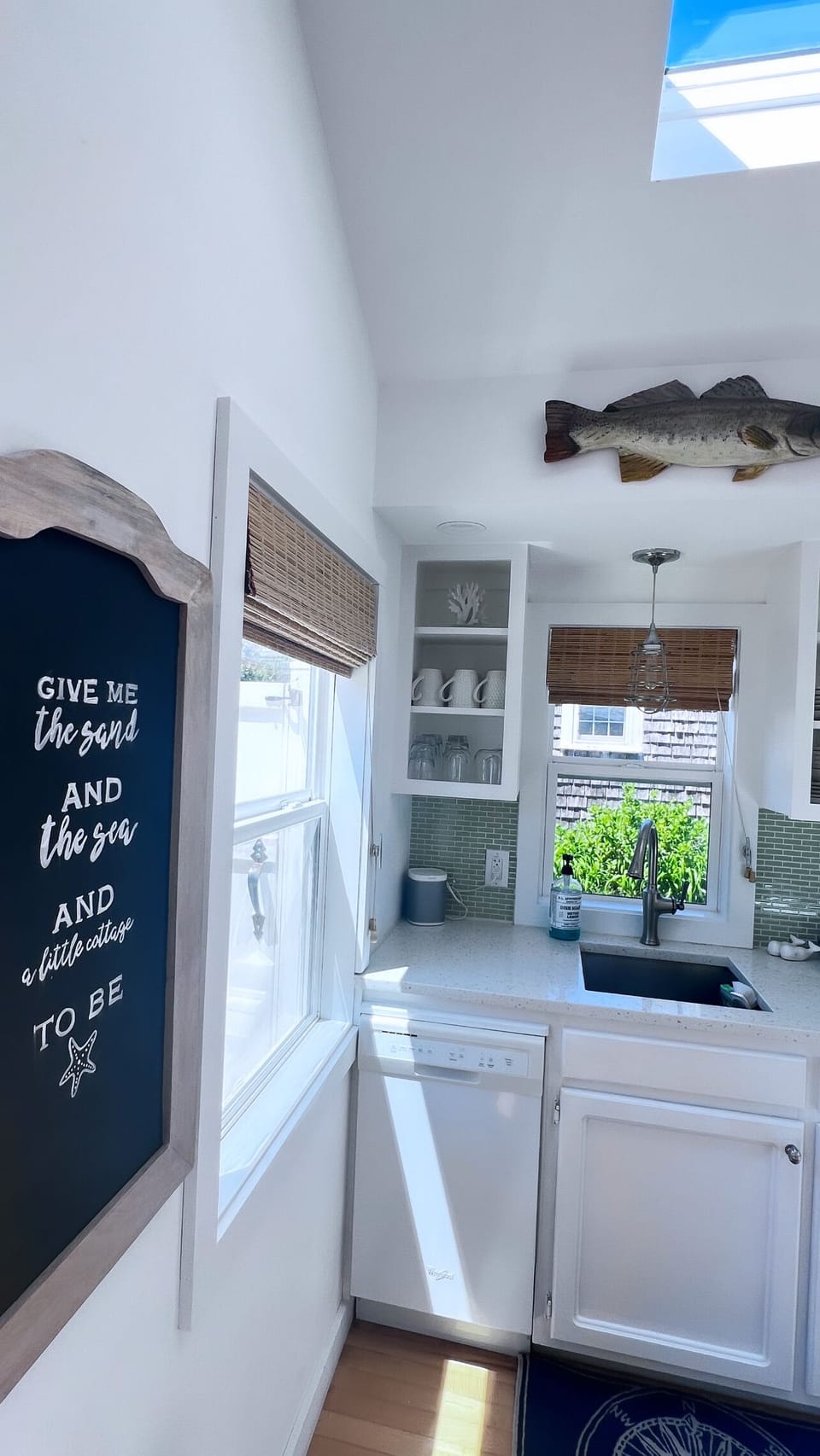 Modern kitchen w/ quartz countertops complete w/ a tiny dishwasher!