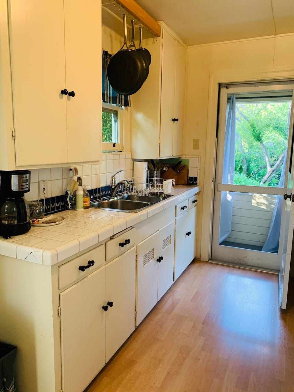Galley kitchen, fully stocked with cooking essentials.  Entrance/Exit door