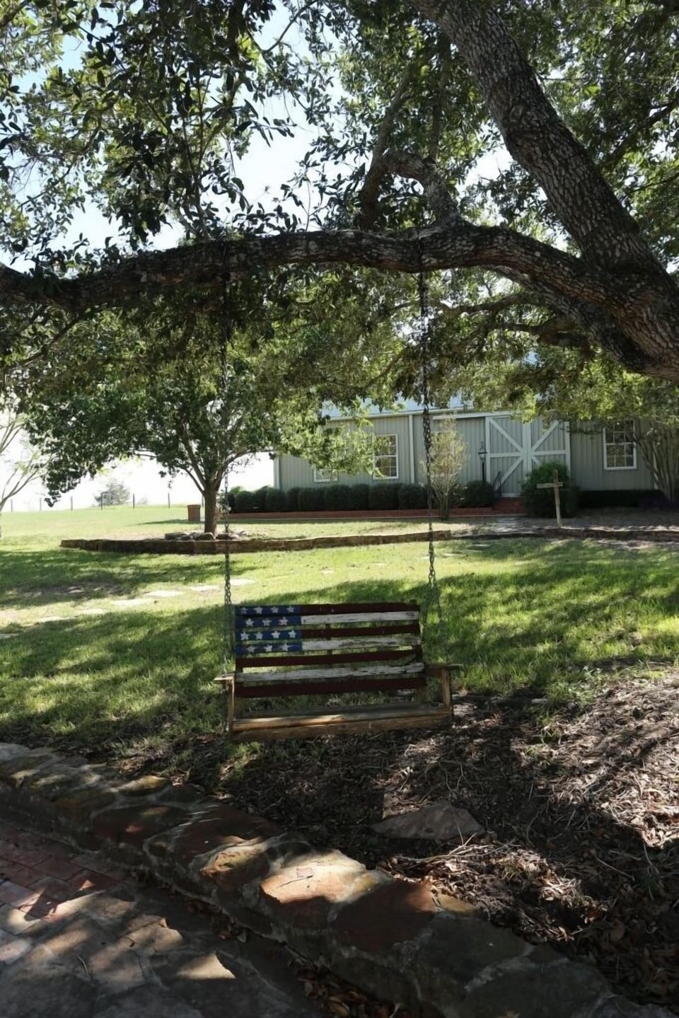 Enjoy the cool breezes on one of the swings under the large oak trees.