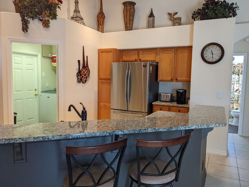 Kitchen is equipped with high end appliances including the adjacent laundry room