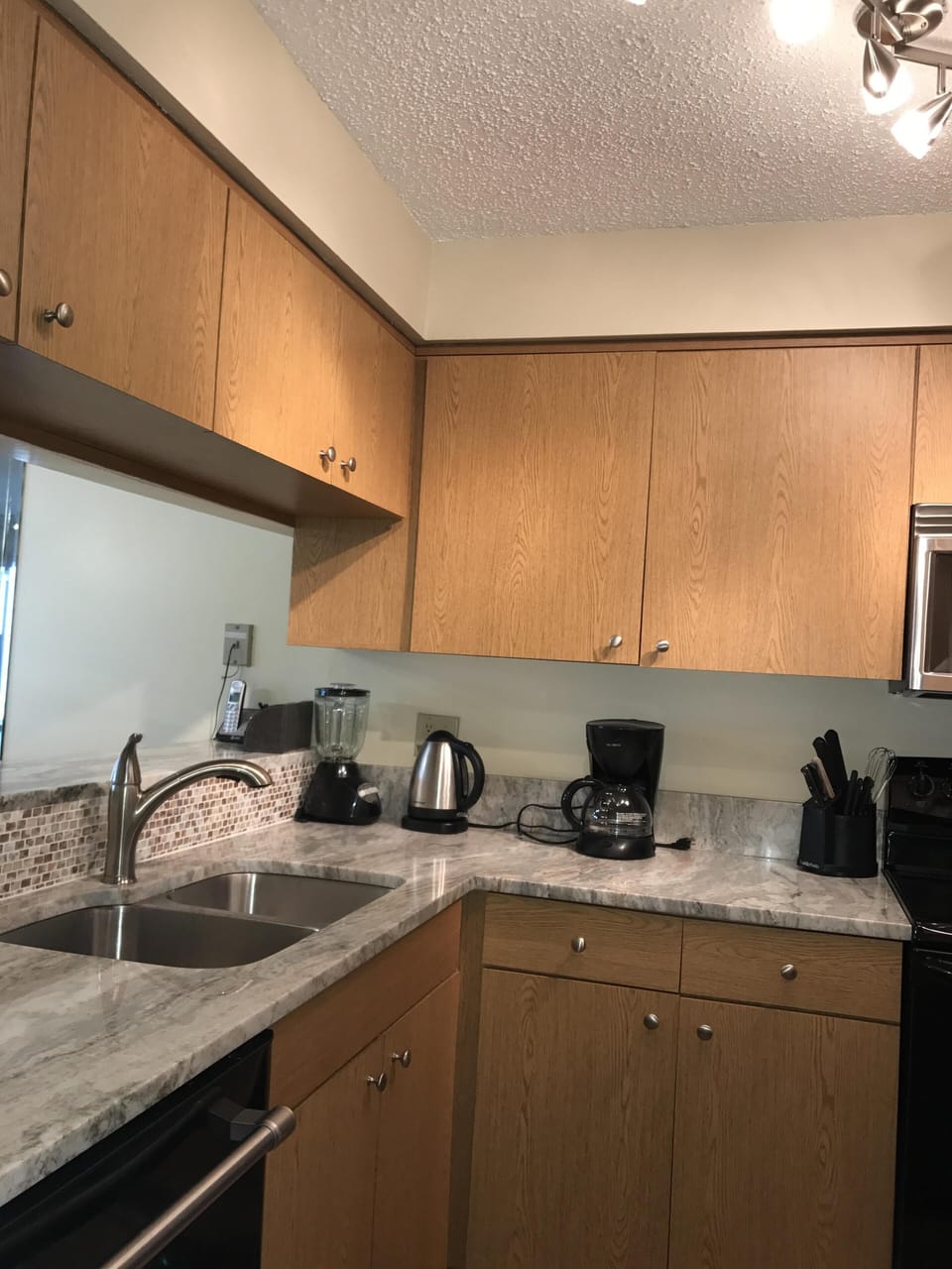Wonderful new granite counter space with mother of pearl backsplash accent