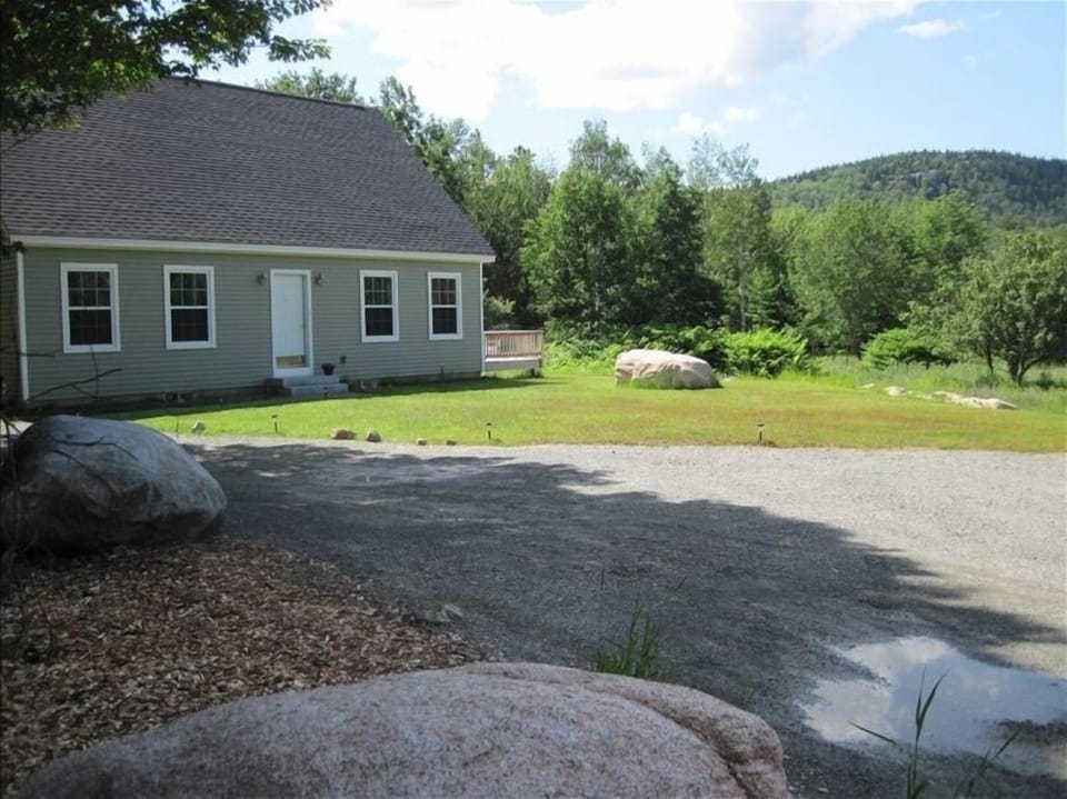front of house from mid-driveway.  House is set back from road
