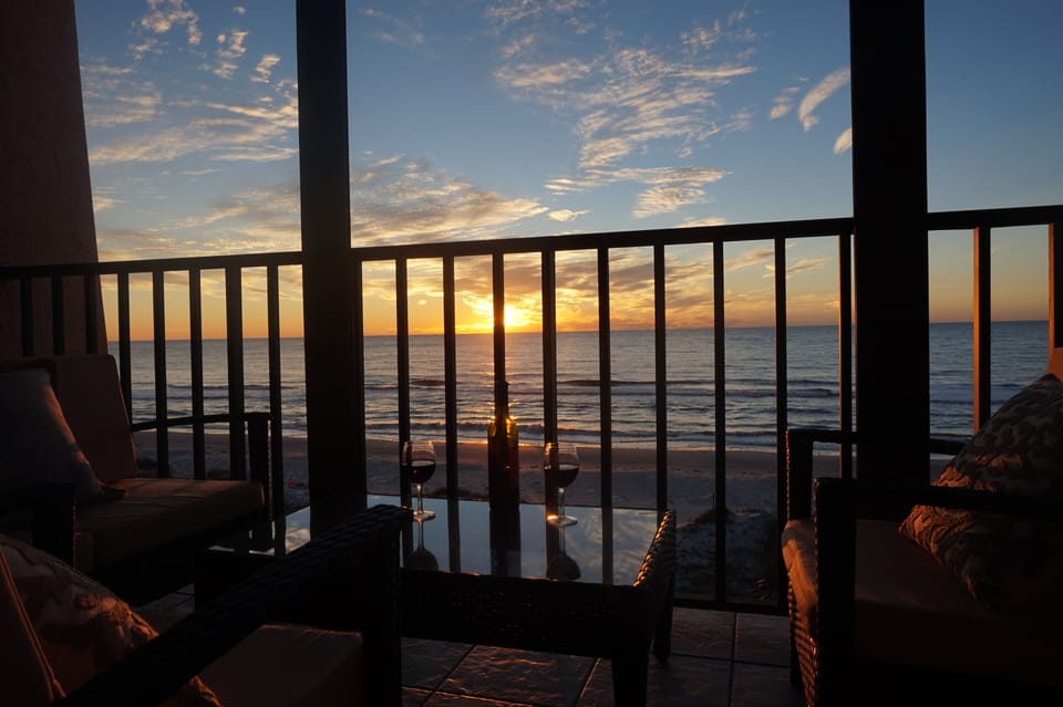 Relax with a  glass of wine while the sun sets over Indian Rocks Beach