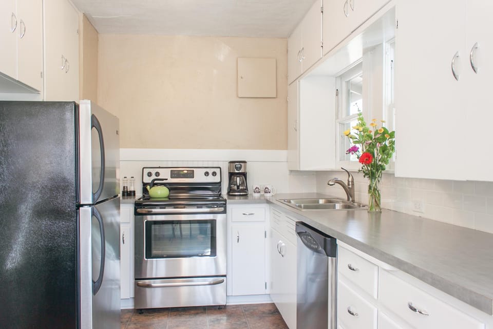 Fully stocked galley kitchen overlooking the backyard. Ready for your gourmet adventures!