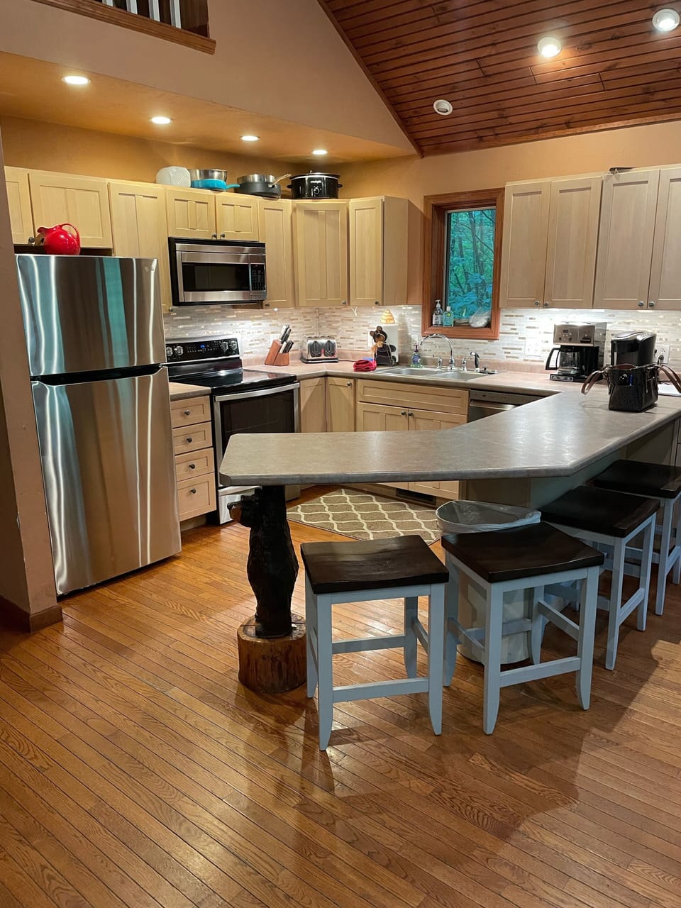 Large kitchen, stainless steel appliances. Microwave is also a convection oven