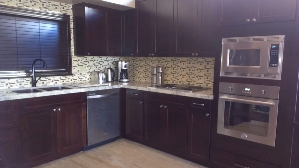 beautiful kitchen with stainless steel appliances and custom finishes