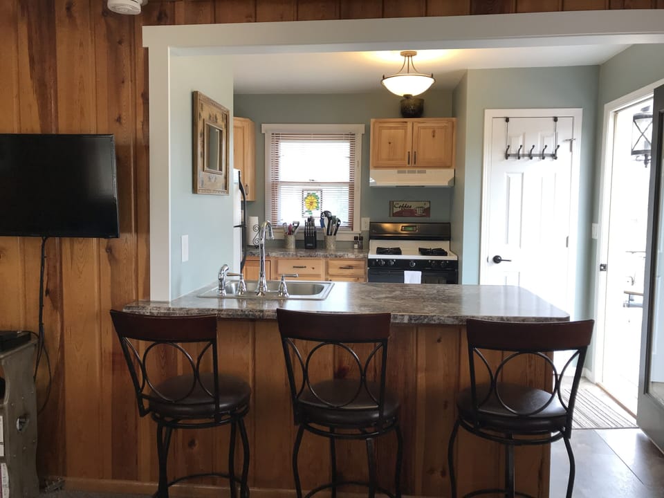 Counter seating along with drop-leaf dining table for eating accommodations. 