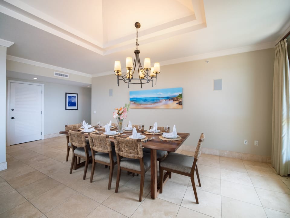 Dine in elegance at the large dining table with seating for eight, while enjoying sweeping views of the ocean just beyond.