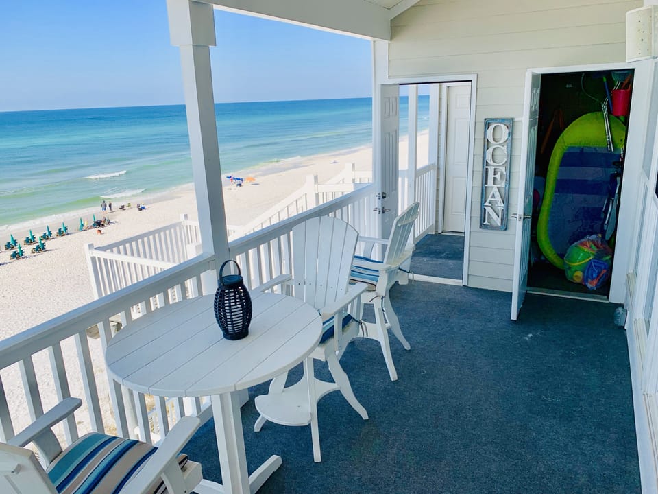 Storage closet with 4 backpack chairs, umbrella, sand toys, and a small cooler 