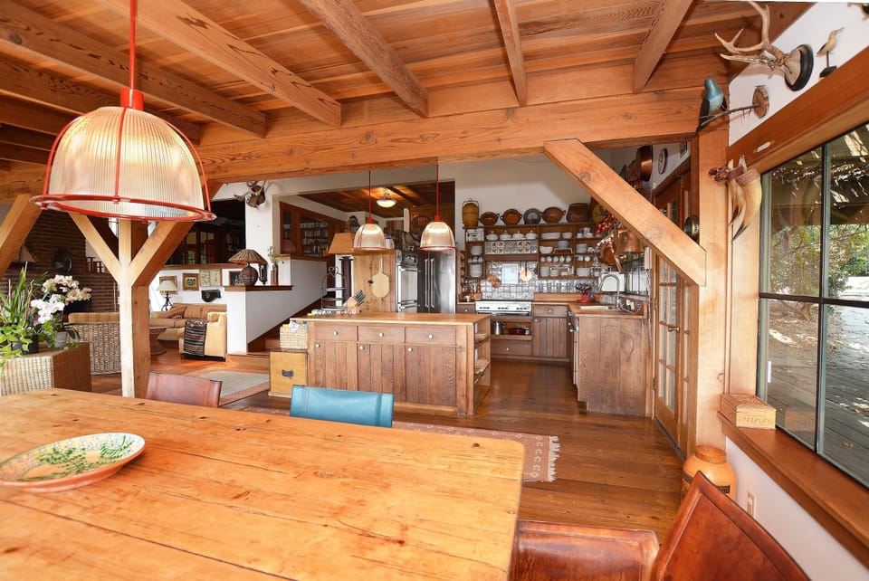 View from sitting at the table towards the kitchen. To the right is the deck