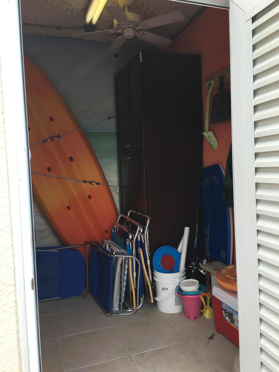 Downstairs Cabana storage with kayak, beach chairs, cooler, many fun items