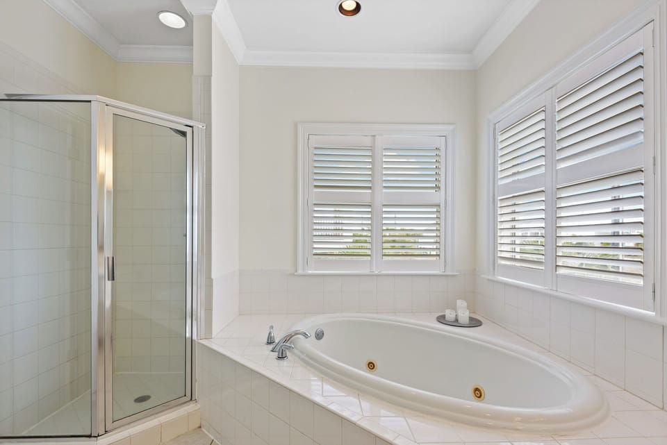 Jetted tub and walk-in shower in the primary ensuite bathroom