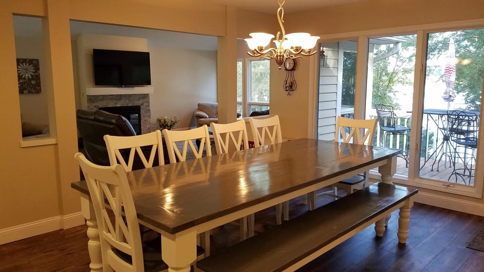 Dining area overlooks lake &  open to family room, doors out to the deck