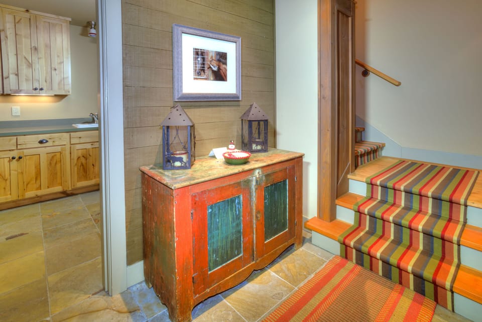 Entrance with slight view of large laundry room with full capacity washer/dryer.