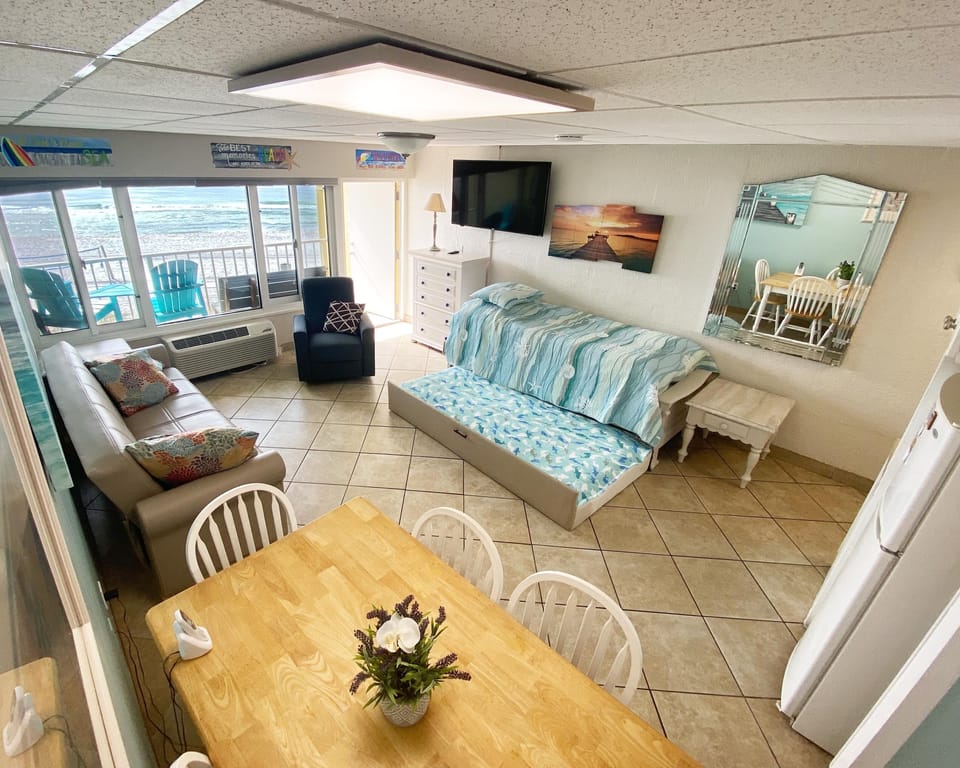 Family room with trundle bed that has 3 twin mattresses, recliner chair, 55"TV 