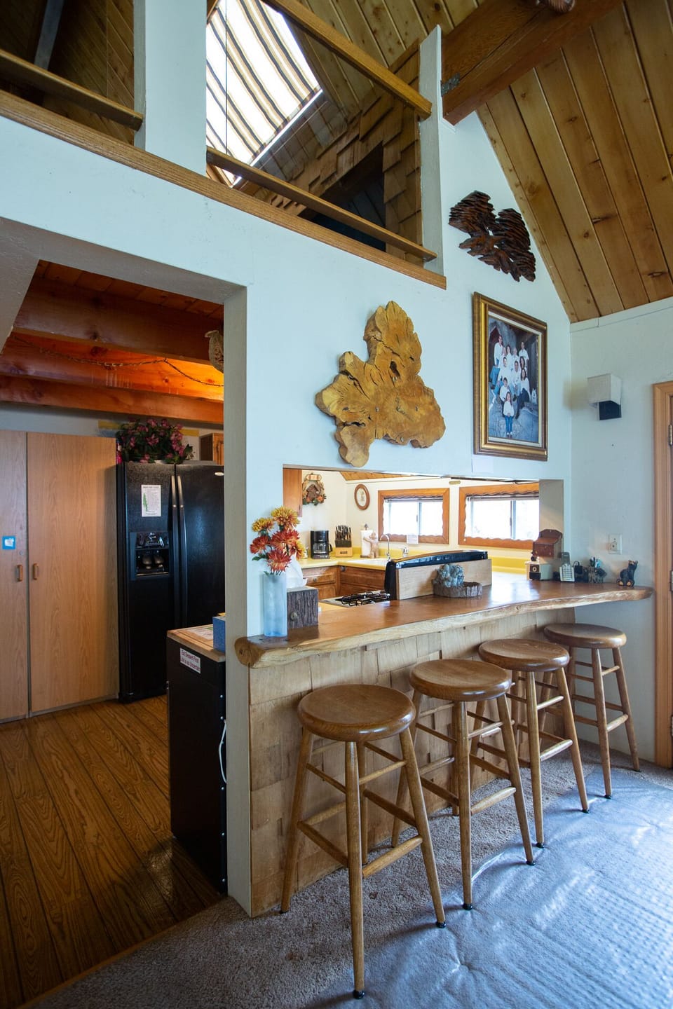 4 seated bar next to kitchen