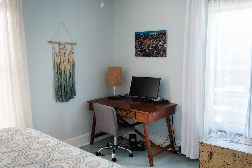 Desk and monitor provided for remote work and school needs.