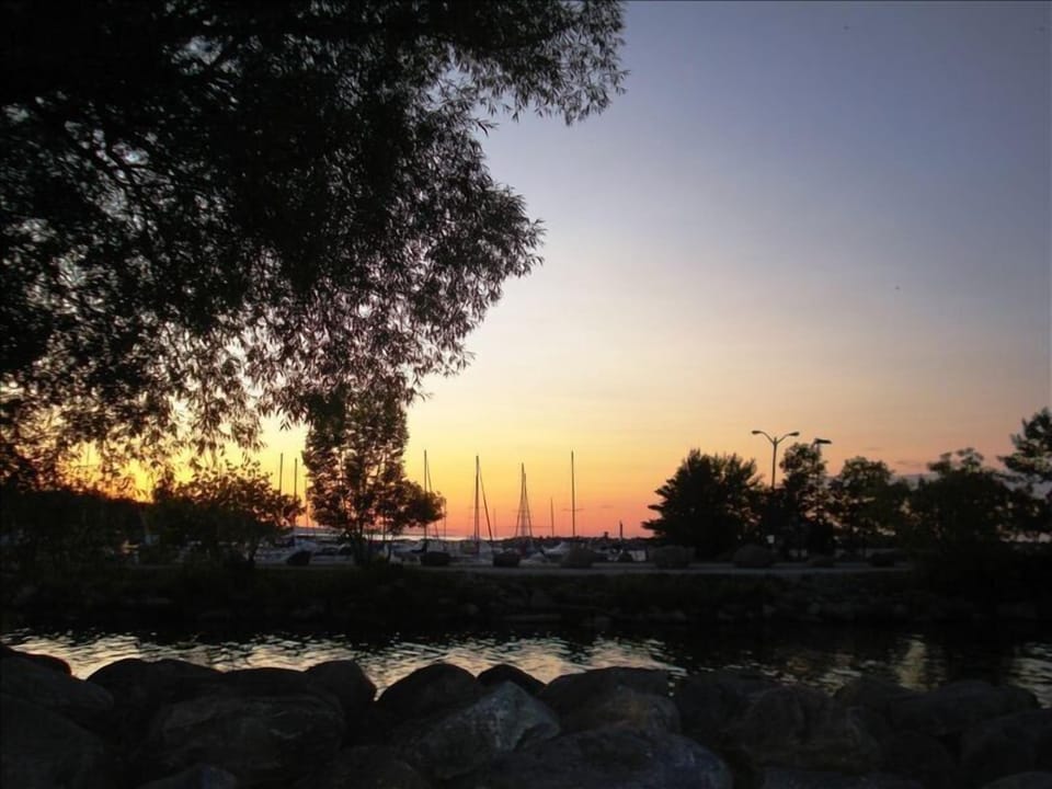 Sailboat masts at sunset -  viewed from cottage deck  