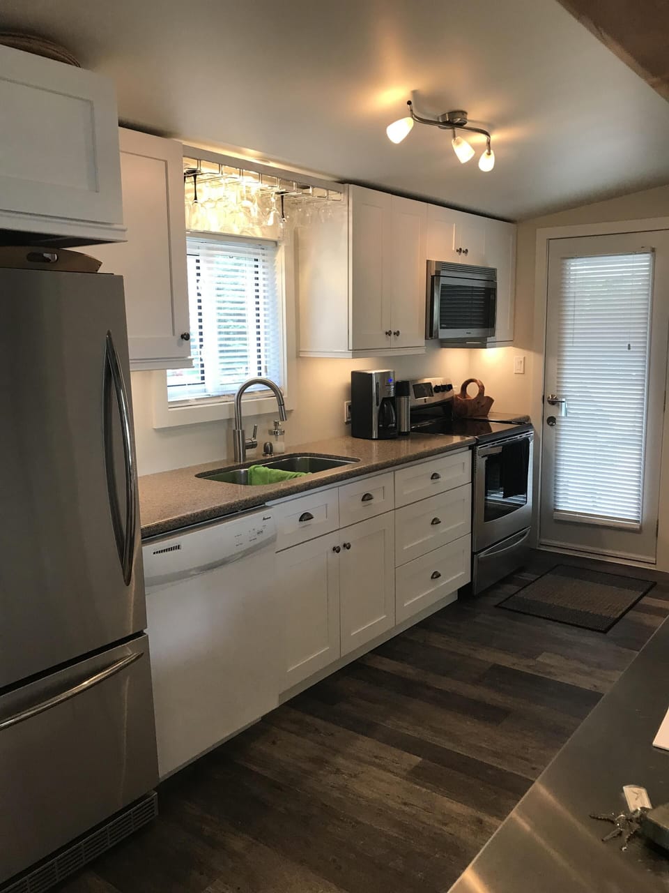 Stainless steel range and high end microwave. Sunny kitchen window faces south