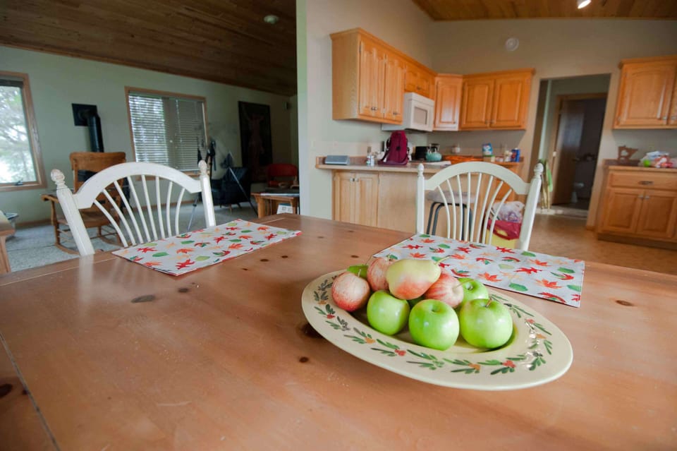 Dining area, kitchen in background.