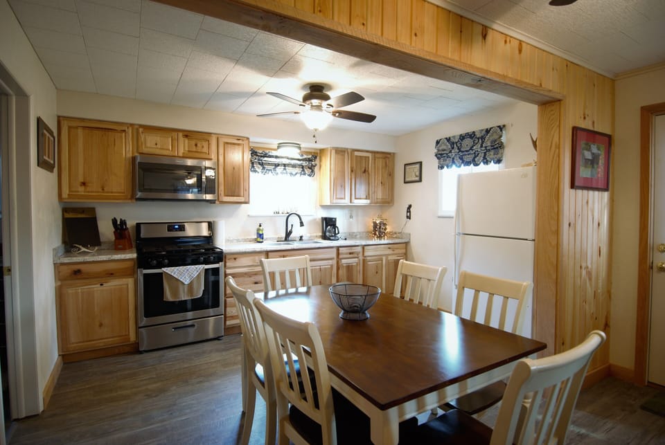 The renovated kitchen is fully stocked and there is seating for six at the table